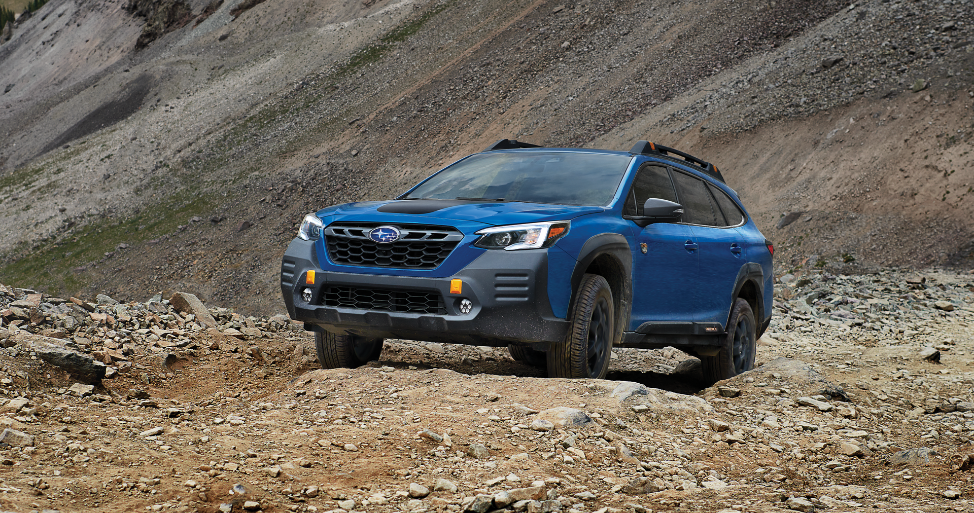 A 2023 Outback Wilderness driving on a trail in the mountains. | Neil Huffman Subaru in Louisville KY