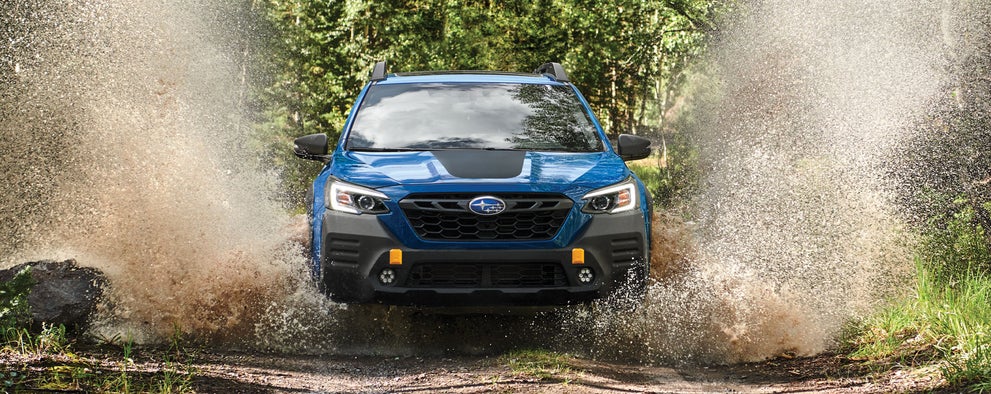 A 2023 Outback Wilderness driving on a muddy trail. | Neil Huffman Subaru in Louisville KY